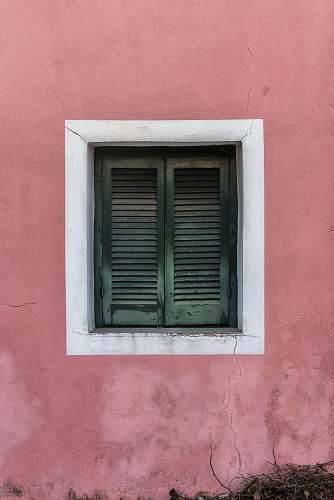 window two green wooden louvered doors curtain
